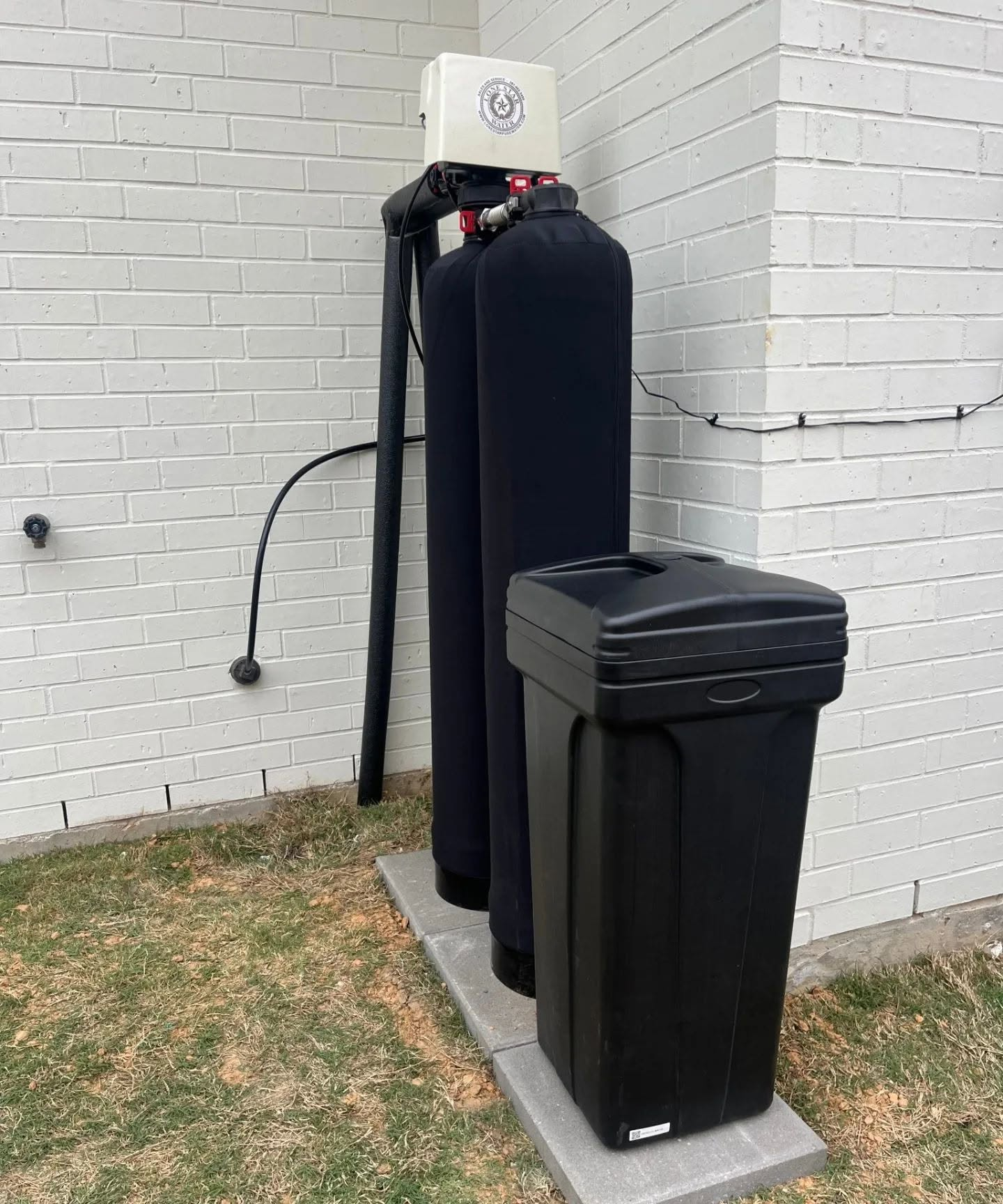 Lone Star Water whole-house treatment system installed outside a home