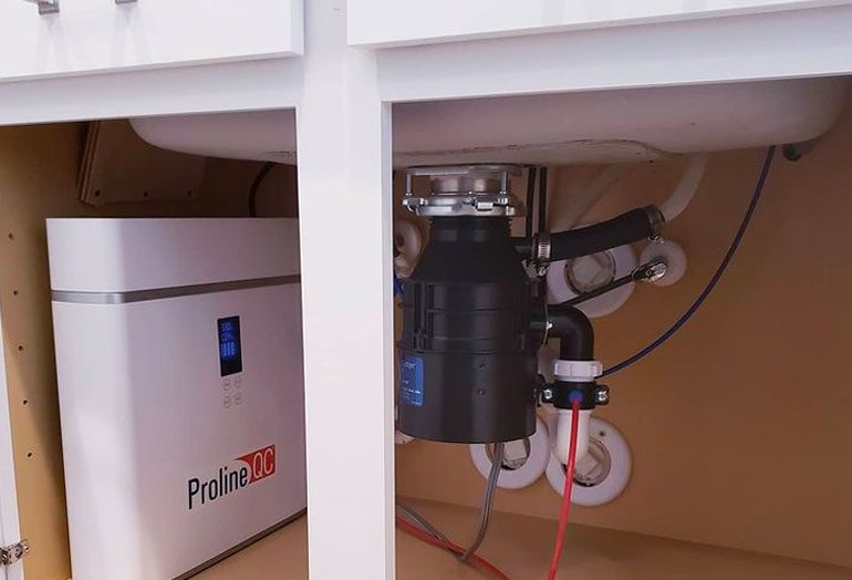 Under-sink garbage disposal and water system.