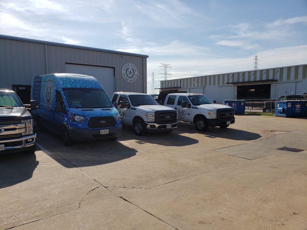 lone star water trucks parked outside a store