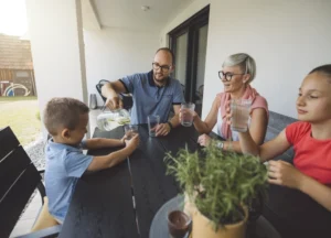 family happily drinking clean water from glasses